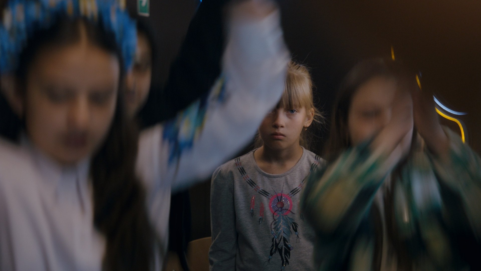 A young girl and schoolchildren play inside a classroom in Kateryna Gornostai’s feature documentary Timestamp, produced by 2Brave Productions. (Source: 2Brave Productions)