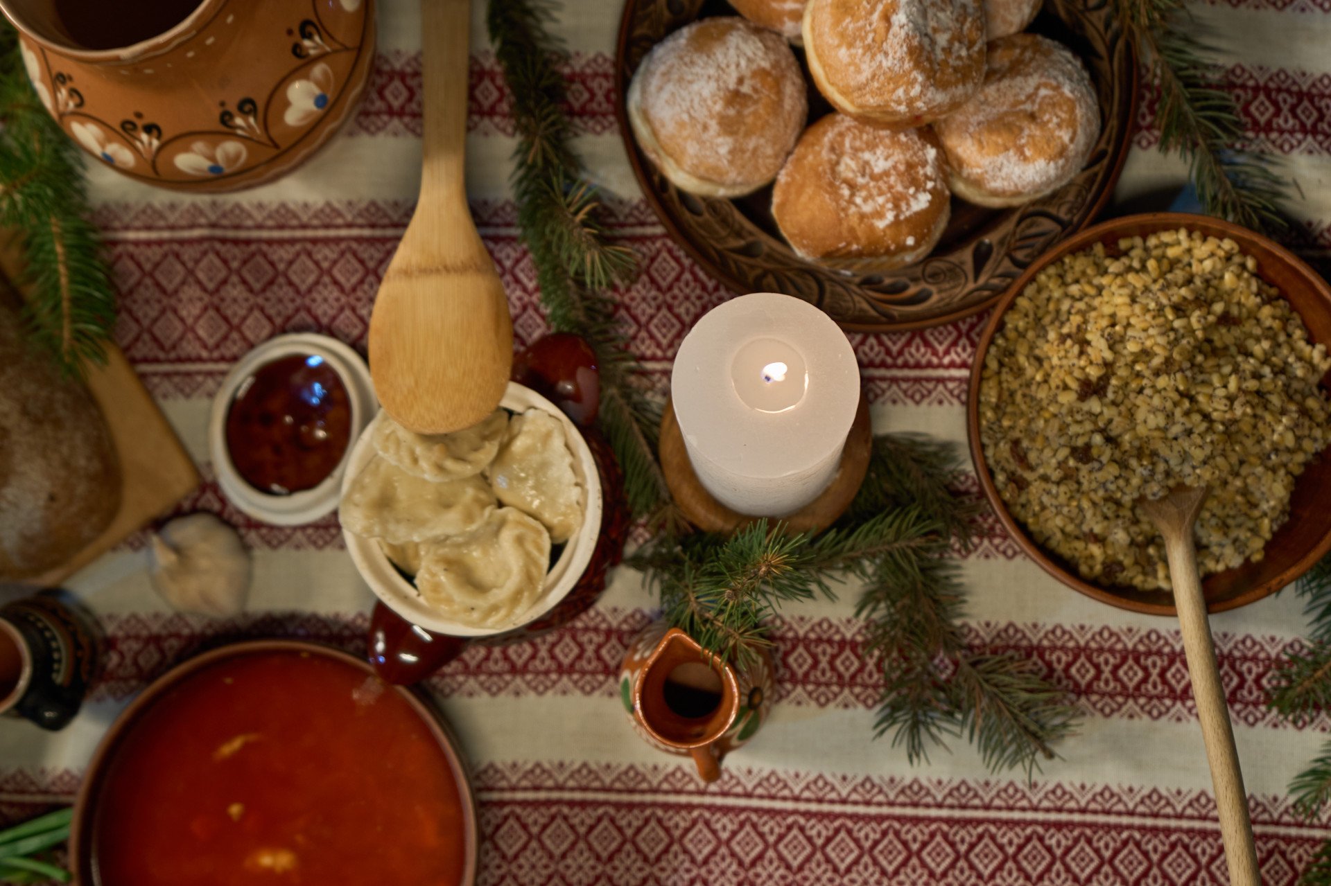 Alongside kutia, the table is often filled with a variety of other dishes. These include uzvar—a sweet, dried fruit compote; holubtsi—stuffed cabbage rolls filled with rice and mushrooms; and borshch, a beetroot soup often served with a dollop of sour cream. Varenyky, or dumplings, stuffed with ingredients like potatoes, mushrooms, or cabbage, are another staple, as well as Ukrainian Christmas bread. Each dish has its own unique meaning. (Photo: Mykyta Shandyba)
