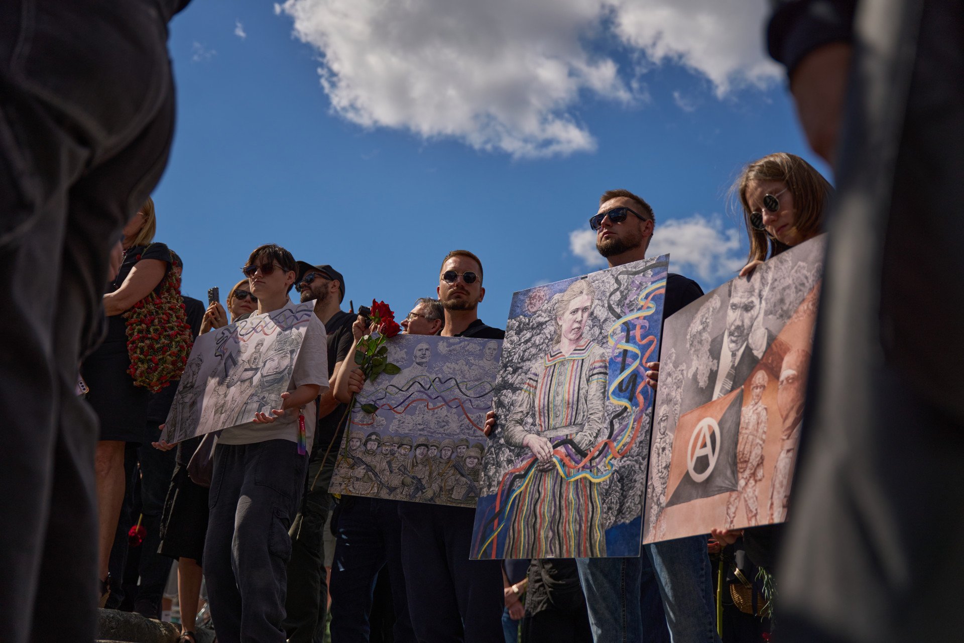 Attendees hold David’s works during the farewell ceremony honoring artist and serviceman David Chichkan at Kyiv’s Independence Square on August 18, 2025, Kyiv, Ukraine. Photo by Mykyta Shandyba/UNITED24 Media.