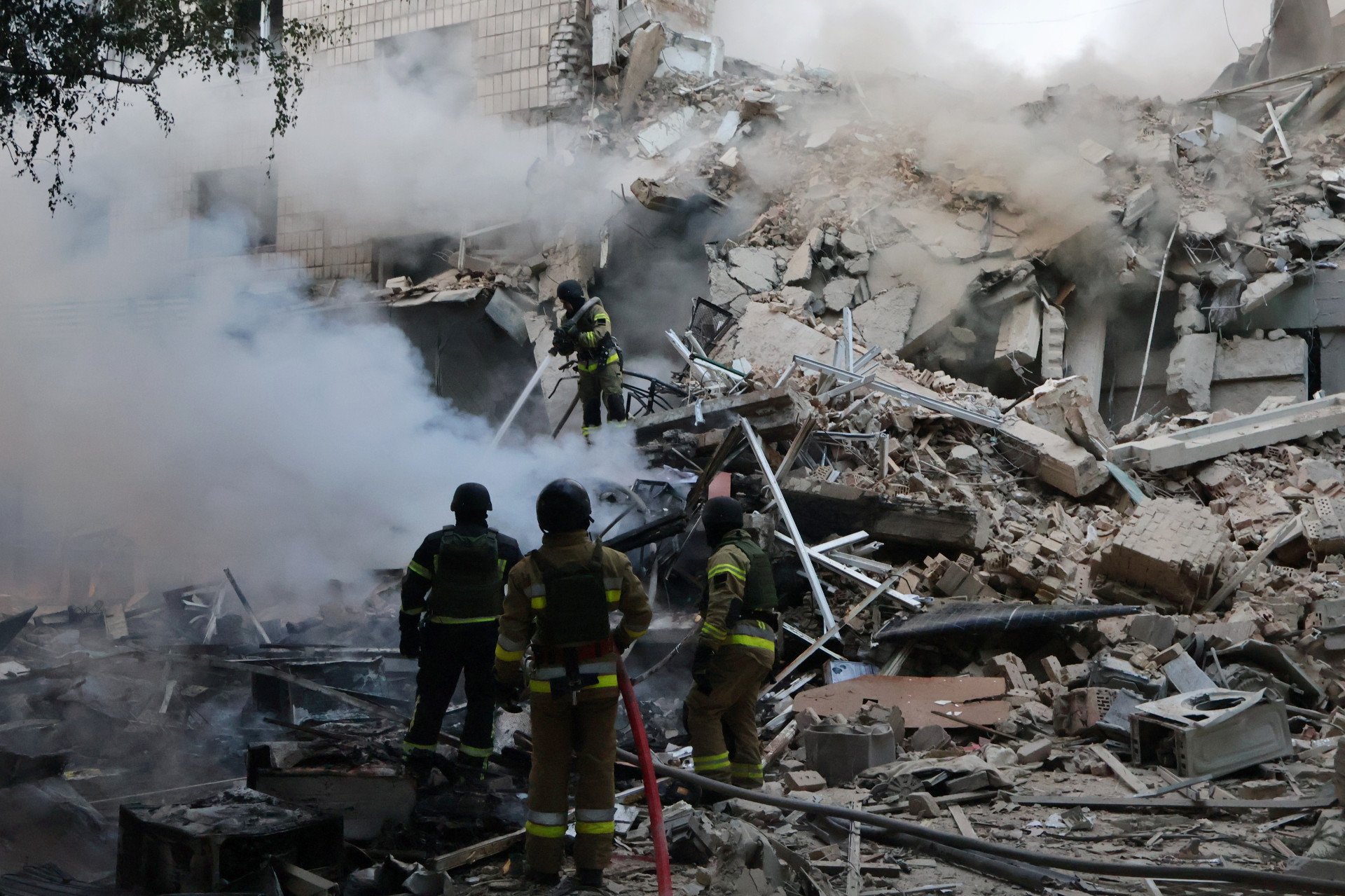 Rescue workers operate at the site of a Russian ballistic missile strike on a nine story residential building in Solomianskyi district, where an entire building's section from the 1st to the 9th floor was destroyed on June 17, 2025 in Kyiv, Ukraine. Rescuers continue to search for people under the rubble. (Photo by Oleksandr Gusev via Getty Images)