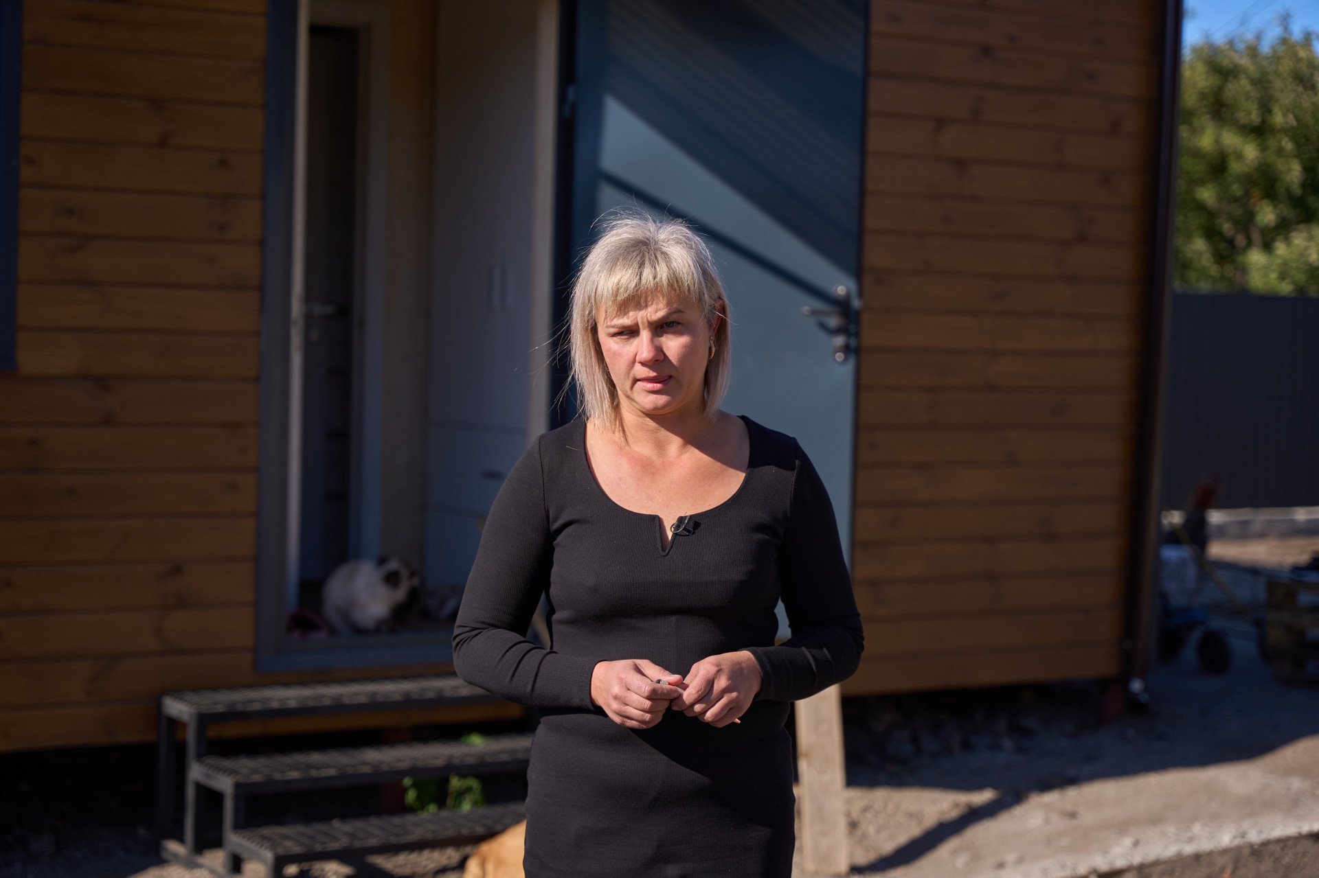 Kateryna is standing in front of a mobile home that was provided to her family after her house was damaged following a Russian drone strike on Kropyvnytskyi, the Kirovohrad region, Ukraine. Photo by Mykyta Shandyba / UNITED24 Media.