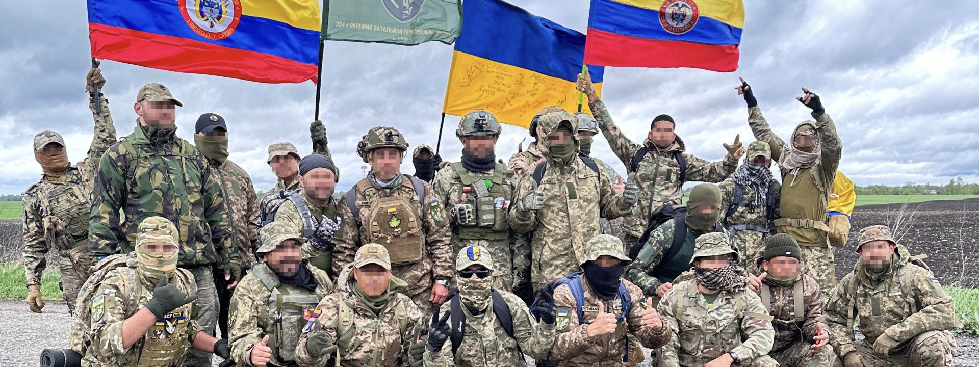 Foreign Legion soldiers proudly display Colombian flags, honoring their home country