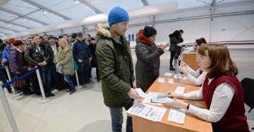 Foreign nationals queue at Moscow’s Sakharovo migration center, where Russia opened military recruitment infrastructure for foreign citizens..