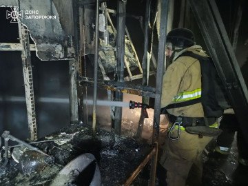 A firefighter works inside a burned structure after Russian drones hit civilian infrastructure in Zaporizhzhia. (Source: State Emergency Service of Ukraine)