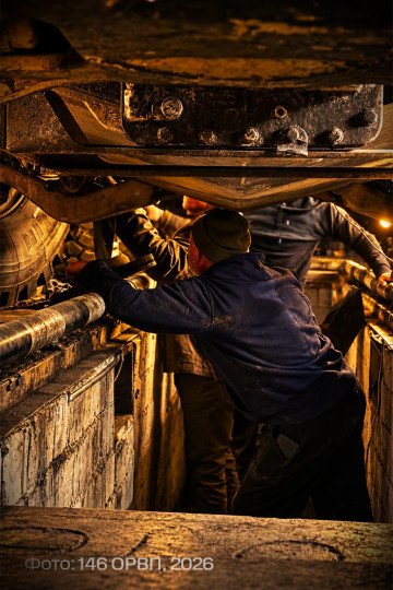 Ukrainian military personnel inspect the underside of a MaxxPro armored vehicle during maintenance. (Source: 146th Separate Repair and Recovery Regiment)
