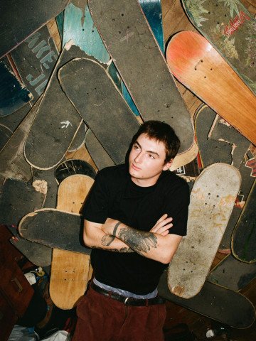A man in a Kharkiv apartment block keeps the skateboards he has used over the years. (Photo: Hironori Kodama)