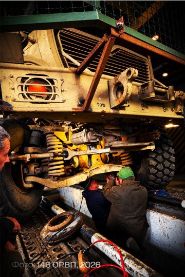 Ukrainian military mechanics repair the front suspension of a MaxxPro armored vehicle at a maintenance facility. (Source: 146th Separate Repair and Recovery Regiment)