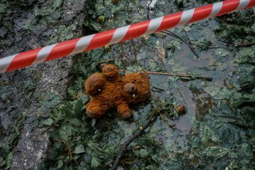Waterlogged children’s toys lie scattered in the wreckage of a Russian missile strike. Kyiv, Ukraine. July 31, 2025. Photo by Josh Olley/UNITED24 Media