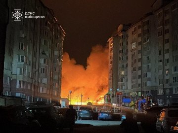 Flames and smoke rise from a burning facility between residential buildings in the Kyiv region after an overnight Russian strike. (Source: DSNS Kyiv) Flames and smoke rise from a burning facility between residential buildings in the Kyiv region after an overnight Russian strike. (Source: DSNS Kyiv)