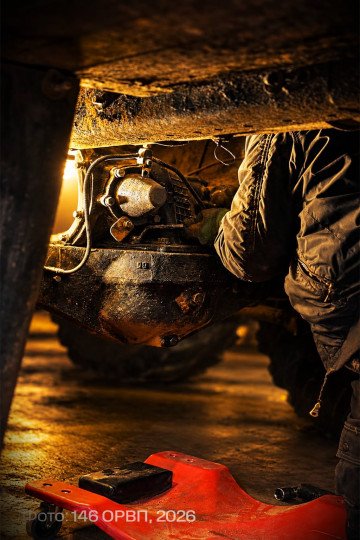 Ukrainian mechanic works on mechanical components beneath a US-supplied MaxxPro armored vehicle. (Source: 146th Separate Repair and Recovery Regiment)