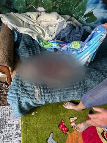 Body of the One-Year-Old Child Covered After the Drone Strike in Pravdyne. (Source: Kherson Regional Military Administration) Body of the One-Year-Old Child Covered After the Drone Strike in Pravdyne. (Source: Kherson Regional Military Administration)