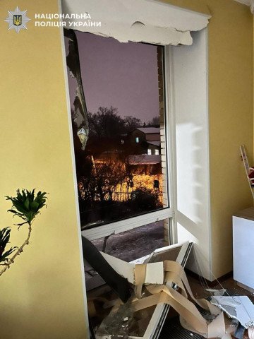 The damage is visible, with the broken glass inside the room and the view of the street outside. (Photo: National Police of Ukraine)