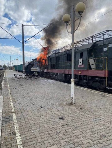 A Ukrainian locomotive burns on the platform in Shostka following a direct hit from a Russian drone. Debris is scattered across the tracks and station. (Source: Andrii Sybiha)