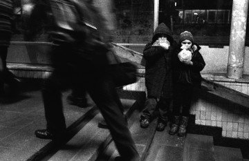 Homeless nine-year-olds Zhenya and Vitya inhale glue at the exit of the Pochaina metro station. Kyiv, 1996. Photo: Oleksandr Glyadyelov 
