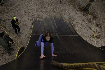A participant climbs the obstacle wall during the race. (Source: Wild Race press office)
