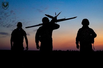 Ukrainian servicemen carry a drone at dusk. (Source: Air Command East)