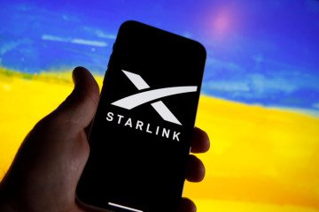 The Starlink logo is seen on a mobile device with a Ukrainian flag in the background in this illustration photo in Warsaw, Poland on 21 September, 2022. (Source: Getty Images)