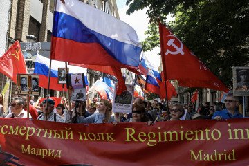 Participants carry banners and flags during an “Immortal Regiment” march in central Madrid marking the WWII victory, while Ukrainian residents stage protests along the route. (Source: Getty Images)