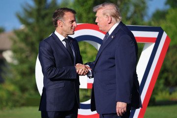 France’s President Emmanuel Macron (L) greets US President Donald Trump during the G7 summit, in Evian, eastern France, on June 15, 2026. (Source: Getty Images)