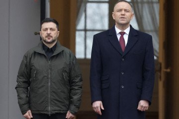 Poland's President Karol Nawrocki and Ukraine's President Volodymyr Zelenskyy attend a welcome ceremony prior to talks at the Presidential Palace in Warsaw, Poland, on December 19, 2025. (Source: Getty Images)