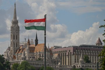 Hungary Open to Joining Ukraine Led Carpathian Eight Alliance After UN Talks The national flag of Hungary waves from a pole with the historic Matthias Church and Fisherman's Bastion complex rising in the background. (Source: Getty Images)