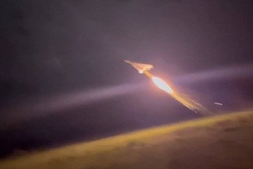 A Shahed-type loitering munition launches into the night sky using a solid-fuel booster. (Source: Russian media)