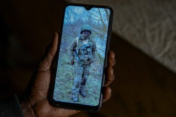 Josephine Ngoya, 50, look at pictures of her son Erastus Mundia, who reportedly died fighting on the Ukrainian frontline after being recruited into the Russian military on February 27, 2026. Illustrative photo. (Source: Getty Images)