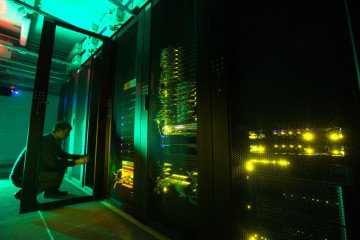 An employee opens a cabinet door of the Sberbank and SberCloud Christofari supercomputer in Moscow, Russia. (Source: Getty Images)