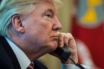 President Donald Trump talks during a telephone call in the Oval Office of the White House of the White House in Washington, DC on June 27, 2017. (Source: Getty Images)
