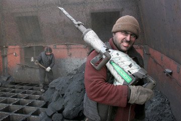 A workman holds a jackhammer for breaking apart coal at an open mine in the Siberian town of Shestaki on February 4, 2009. (Source: Getty Images)