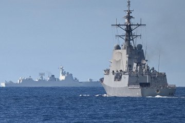 Illustrative image. A Chinese PLA Navy ship (L) is seen while the Royal Australian Navy destroyer HMAS Brisbane (R) takes part in a maritime cooperative activity near Scarborough Shoal, South China Sea, on September 3, 2025. (Source: Getty Images)