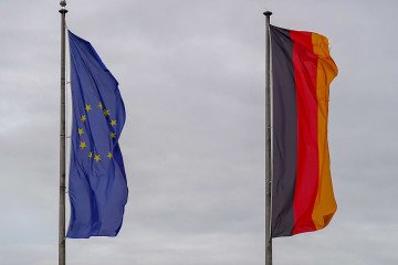 The German national flag and the European Union flag fly at the harbor in Friedrichshafen, Baden-Wuerttemberg, Germany. (Source: Getty Images)