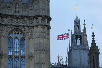 The Palace of Westminster with the UK flag is seen on the street in London, United Kingdom. (Source: Getty Images)