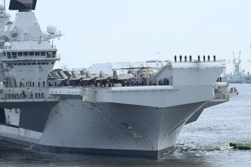 HMS Prince of Wales anchors in Tokyo on August 27, 2025, during Operation HIGHMAST, leading the British Carrier Strike Group’s 26,000-nautical-mile Indo-Pacific deployment. (Source: Getty Images)