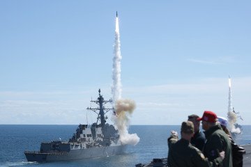 US President Donald Trump observes a demonstration from the deck of the USS George H.W. Bush aircraft carrier on October 5, 2025, off the eastern coast of the United States. (Source: Getty Images)