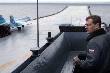 Dmitry Medvedev stands on the flight deck of the aircraft carrier Admiral Kuznetsov during the “Stability 2008” military exercises in the Barents Sea, October 11, 2008. (Source: Getty Images)