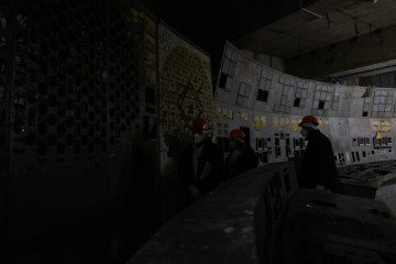 Employees stand at the control panel of the fourth power unit in Chornobyl Nuclear Power Plant, in Chornobyl, on December 22, 2025, amid the Russian invasion of Ukraine. (Source: Getty Images)