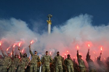 Ukrainian Azov Brigade servicemen hold flares during a memorial event in Kyiv marking the second anniversary of the Olenivka prison attack, July 28, 2024. (Source: Getty Images)