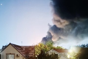 A massive plume of smoke rises over residential buildings following a Ukrainian drone strike on the Edelweiss-95 fuel depot on September 28. (Source: OSINT channel Exilenova+)