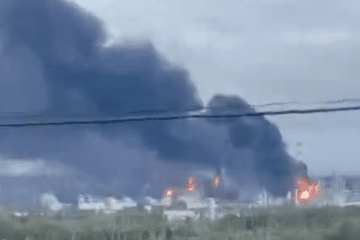A large fire burns at an industrial facility, sending thick black smoke into the air. (Exilenova+)