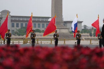 Chinese honor guards hold national flags of China and Russia to welcome Russian leader Vladimir Putin on May 20, 2026 in Beijing, China. (Source: Getty Images)