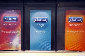 Packets of Durex condoms, produced by Reckitt Benckiser Group Plc., are seen on a supermarket shelf. (Source: Getty Images)