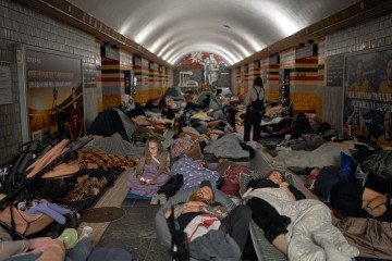 Local residents take shelter and sleep inside a subway station during an air raid alert in the early hours of August 20, 2026 in Kyiv, Ukraine. (Source: Getty Images)