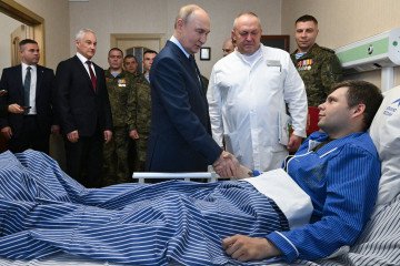 Russian leader Vladimir Putin visits servicemen who were wounded during the Russian military action in Ukraine, at a military hospital in Moscow on October 29, 2025. (Source: Getty Images)