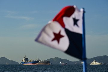 Russian Drone Attack on Foreign-Flagged Ships in Black Sea Kills One, Injures Five A Panamanian flag is pictured in front of cargo ships waiting to enter the Panama Canal in Panama City on January 25, 2025. Illustrative photo. (Source: Getty Images)