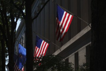 American flags hang on the side of the Robert F. Kennedy Department of Justice Building. (Source: Getty Images)