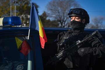 A female member of the Romanian Intelligence Service (SRI) takes part in a military parade on the National Day of Romania in Bucharest on December 1, 2021.