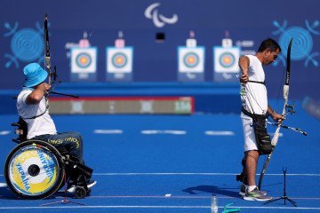 Serhiy Atamanenko of Team Ukraine and Jahan Musayev of Team Azerbaijan shoot arrows during a para archery training session ahead of the Paris 2024 Summer Paralympic Games at Invalides on August 26, 2024 in Paris, France. Undeterred by War, Ukrainian Paralympic Team Set to Shine in Paris