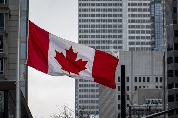 A Canadian flag is lowered to half-staff at the Guy-Favreau Complex. (Source: Getty Images)