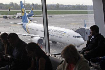 Passengers wait in the premises of the Boryspil International airport. (Source: Getty Images)